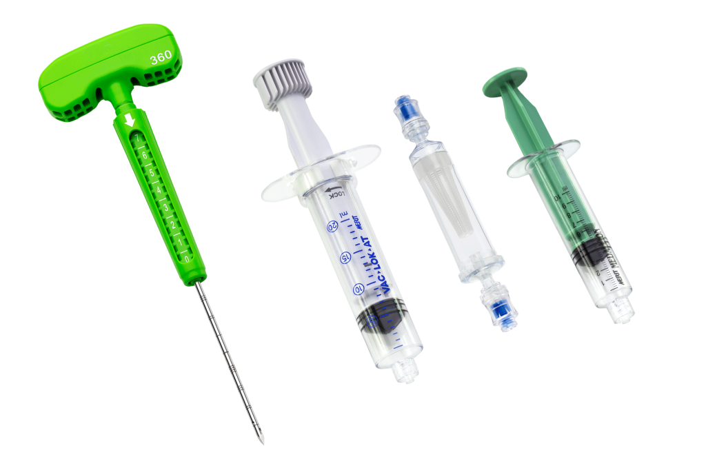 A collection of syringes and a needle arranged on a flat surface, used for medical purposes.